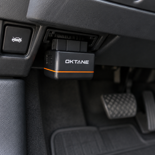 Oktane One plugged into a car OBD port under the dashboard (concept render)